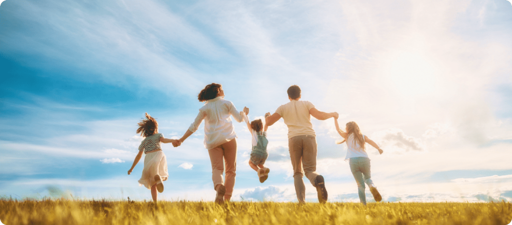 Happy family running in field